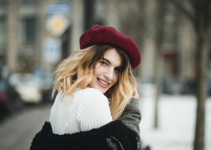 Selective Focus Photography of Smiling Woman Wearing Red Hat during Snowy Day