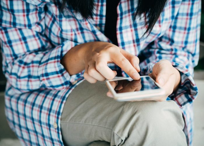 Person using phone to book home tutors