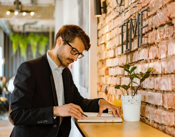 Man in Black Suit Jacket Using Laptop Computer